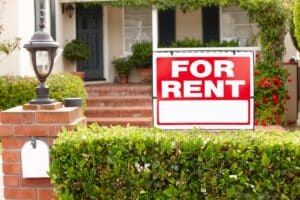 primary residence with for rent sign in front yard